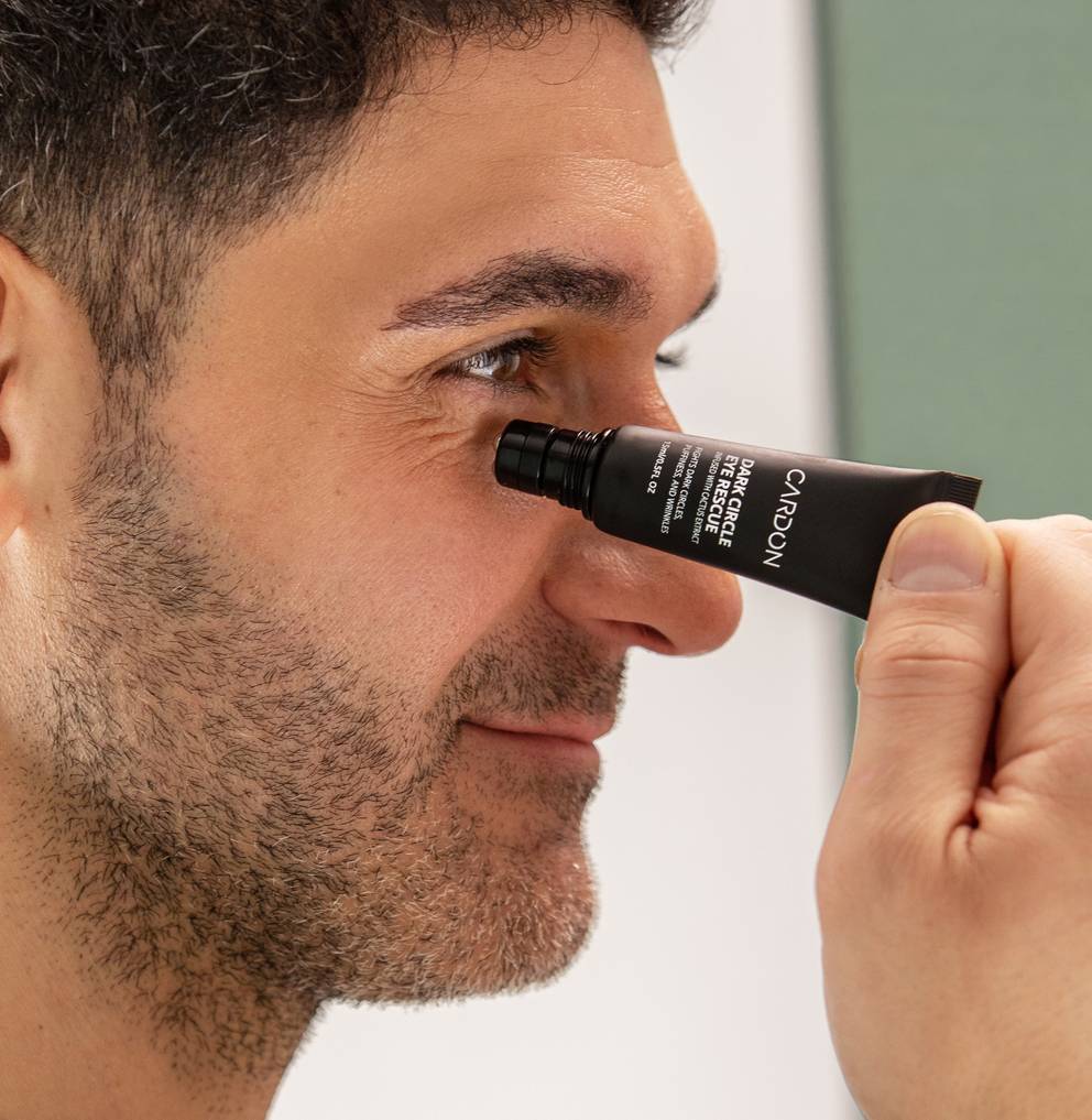 Model applying Cardon's Dark Circle Eye Rescue to his under eye dark circles